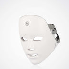 White LED face mask on a light gray background