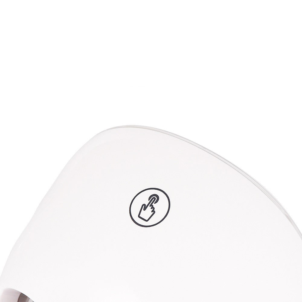 Close-up of a white electronic device with a black icon on a white background