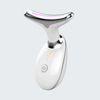 White and silver facial massager on a light gray background