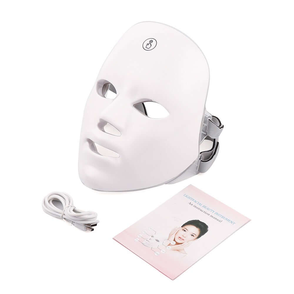 White LED face mask with cable and user manual on a white background